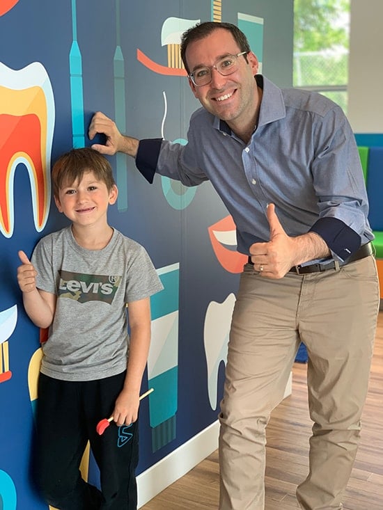 Thumbs Up - Dr. Noah with a child patient.